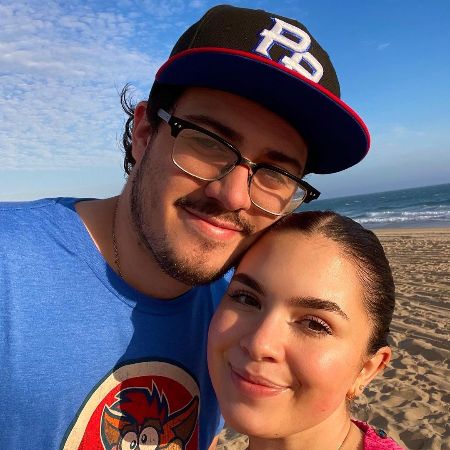 Cristian Marcus Muñiz and his long-time girlfriend took a picture together at the beach.